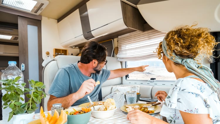 a-happy-couple-spending-time-together-having-fun-dinner-in-an-rv